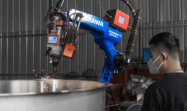 Automated welding robots performing precision welding operations